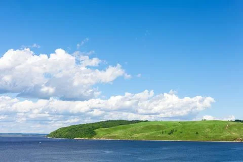 The sun is shining and the clouds, river, forest in summer nature Stock Photos