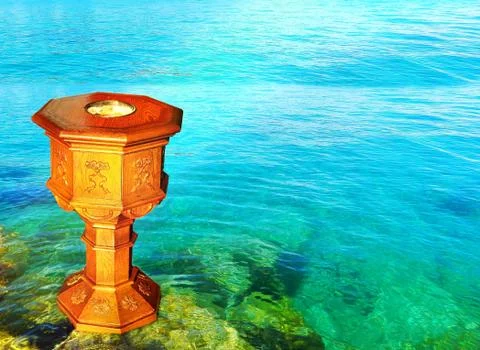 Sun shining on baptismal font in front of clear pristine water Stock Photos