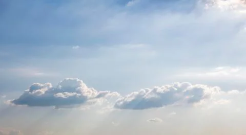 Sun shining on beautiful fluffy clouds in bright blue sky. Inspirational and Stock Photos