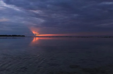 Sun shining from behind clouds cloudy sunset Stock Photos