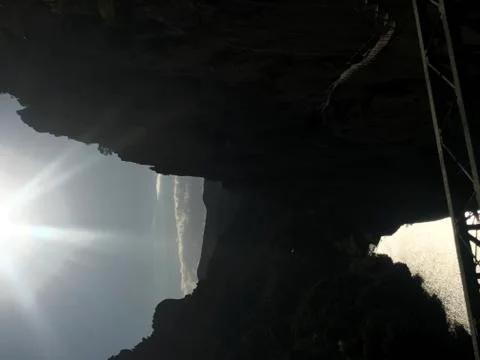 Sun shining between two mountains Stock Photos