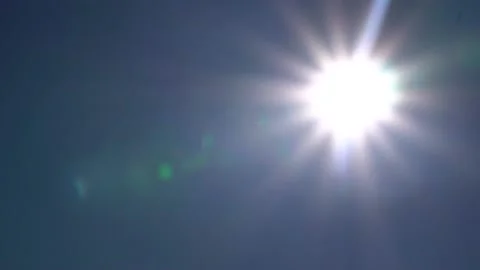 The sun shining in the blue sky thru the camera elements in 1080p 59.94p Stock Footage 167894780