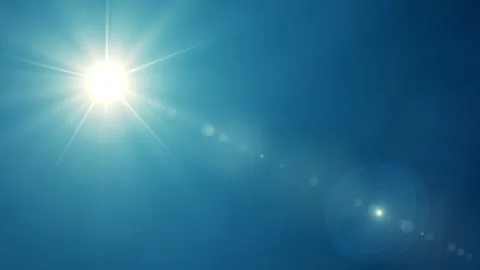 The sun is shining brightly with glare on a blue background. Abstract animation Stock Footage 288520678