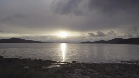 Sun shining in the calm river at dusk Stock Footage 85828627