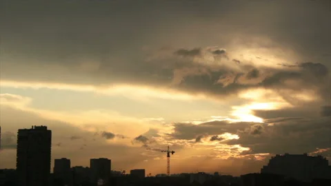 Sun shining in clouds over town Stock Footage 129042670