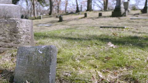 Sun shining down on Father headstone at Greenwood Cemetery, 4k60p Stock Footage 128785066