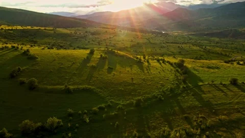 The sun is shining on a field of green grass Stock Footage 327908158