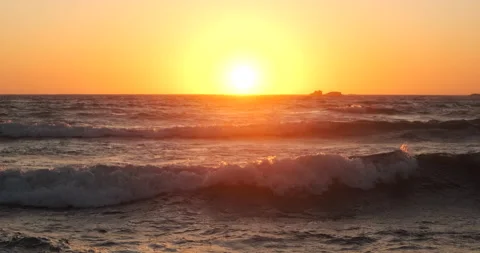 Sun shining on horizon at sunset on the ocean Stock Footage 131899218