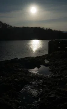 Sun shining on lock and puddle Stock Photos
