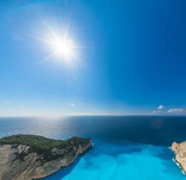 Sun shining over cliffs in Shipwreck Cove Stock Photos