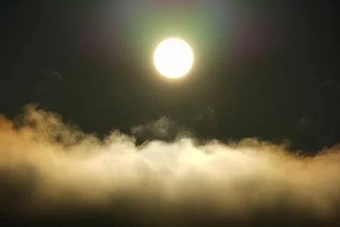 The sun shining over the clouds in the sky. Stock Photos