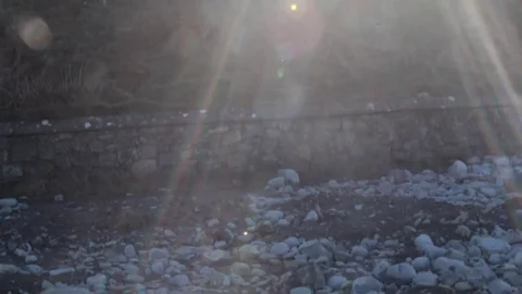 The Sun Shining Over a Hill, Resulting in a Lens Flare Video stock 85394380