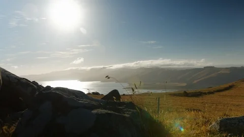 Sun shining over hills and ocean East Coast, New Zealand Vídeos de archivo 88380458