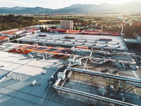 Sun is shining over a large logistic center building in the countryside Stock Photos