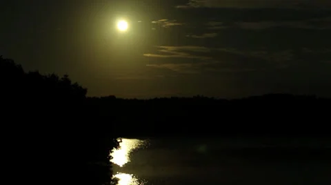 Sun shining over river in silhouette Stock Footage 32186352