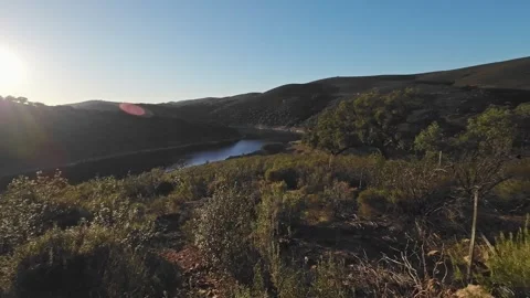 Sun shining over serene river valley landscape in Monfrague Extremadura Spai Stock Footage 340551597