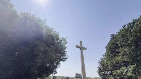 Sun shining over stone cross monument panning Stock Footage 340195830