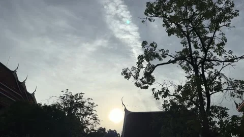 The Sun Shining On Sky With Clouds And Birds Flying, Silhouette Trees And Roof Stock Footage 277346151