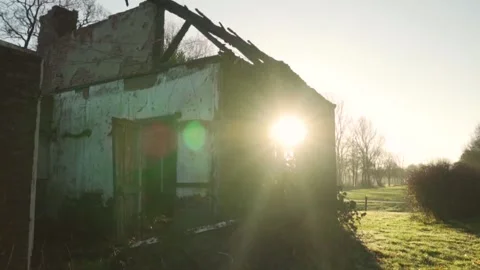 Sun shining through the broken window of an abandoned building Stock Footage 291882858