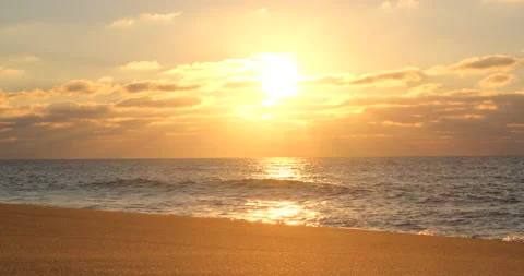 Sun shining through clouds on beach at sunset in Portugal. Stock Footage 146669241