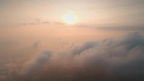 Sun shining through clouds during sunset, aerial drone Stock Photos
