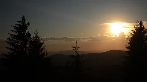 Sun shining through clouds over forest Stock Footage 63303168