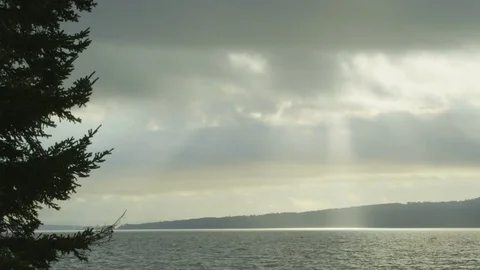 Sun shining through clouds over nova scotia bay Stock Footage 74096284