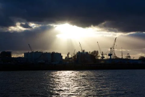 Sun Shining through Clouds over the Harbor Stock Photos