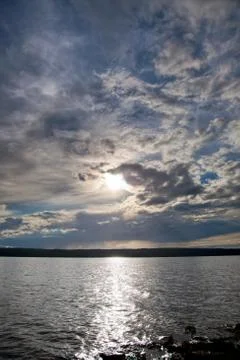 Sun shining through clouds Stock Photos