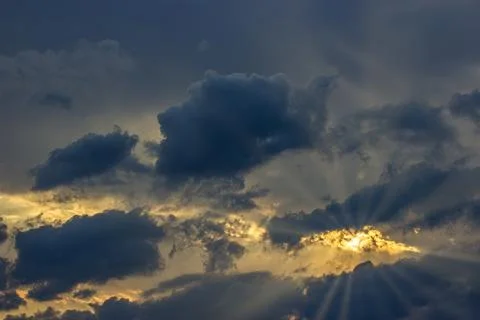 Sun shining through clouds on a stormy day Stock Photos