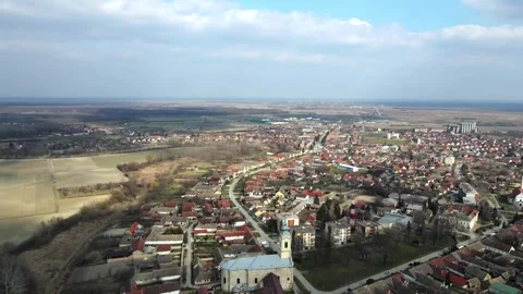 Sun shining through the clouds on town Bac, Serbia viewed from above Stock-Footage 258608817
