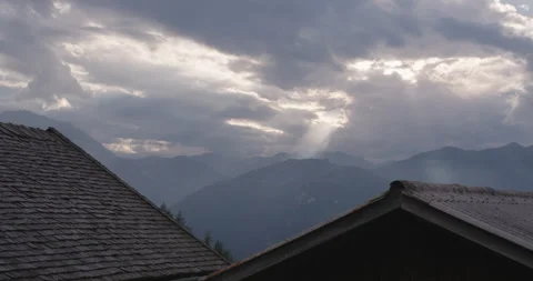 Sun shining through cloudy on a mountain in the Austrian alps Stock Footage 230403514