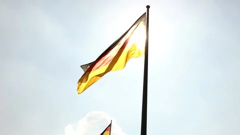 Sun shining through the flag of Germany Stock Footage 144076193