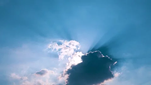 The sun shining through fluffy clouds and blue sky background Stock Footage 303894286