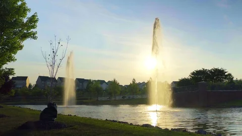 Sun Shining through Fountain Stock Footage 77111353