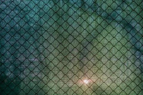Sun shining through the green net and a fence Stock Photos