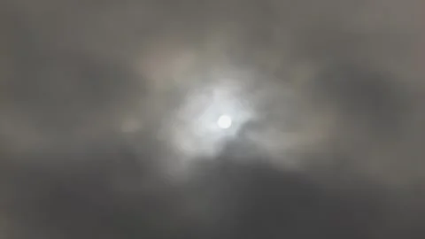 The Sun shining through overcast cloud cover in slow motion stock footage Stock Footage 338027903