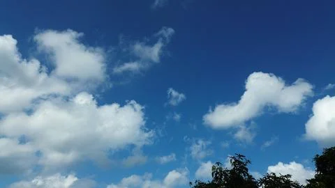 Sun shining through the puffy clouds. Stock Photos