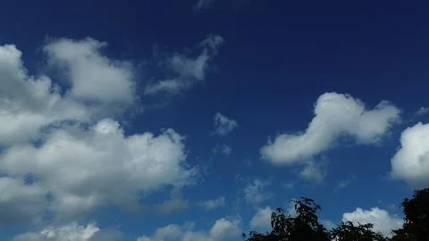 Sun shining through the puffy clouds. Stock Photos