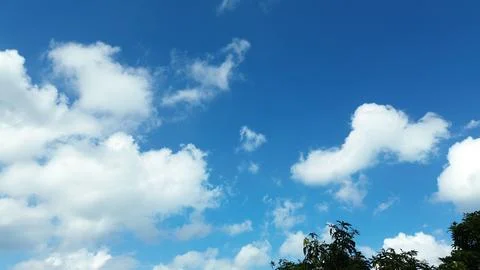 Sun shining through the puffy clouds. Stock Photos