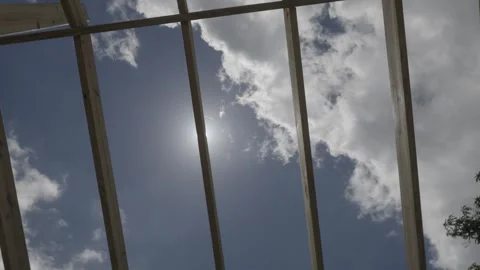 Sun shining through roofing beams Stock Footage 340820416