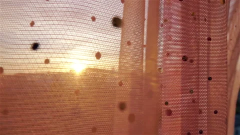 Sun shining through transparent sparkling curtain in light breeze. 库存影片 235007251