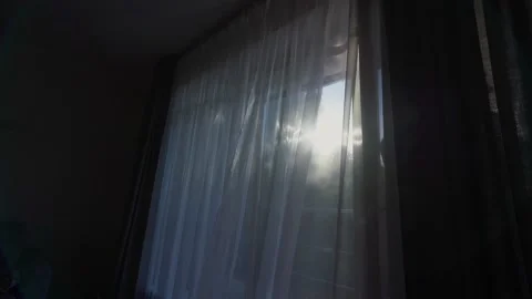 Sun shining through transparent white curtain hanging on window Video stock 222623974