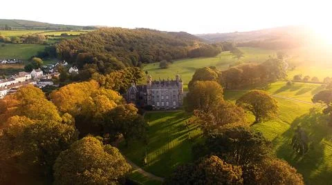 Sun shining through trees beside Castle at golden hour Autumn in Ireland Stock Photos