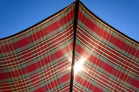 Sun shining through umbrella Stock Photos
