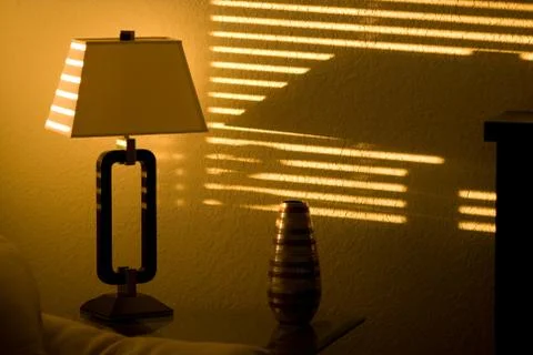 Sun shining through window blinds Stock Photos