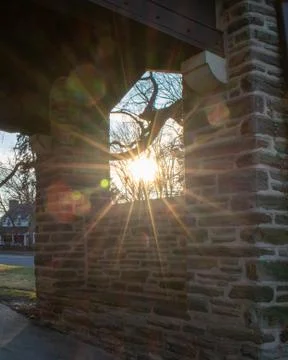 The Sun Shining Through a Window in a Cobblestone Wall Stock Photos
