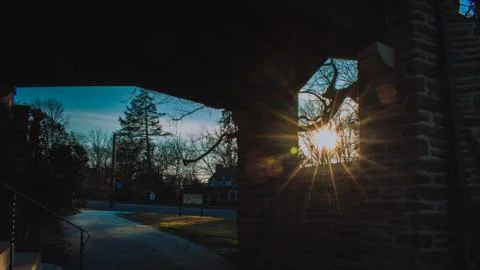 The Sun Shining Through a Window in a Cobblestone Wall Stock Photos