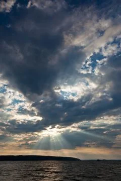 Sun shining thru clouds Stock Photos