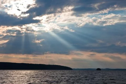 Sun shining thru clouds Stock Photos